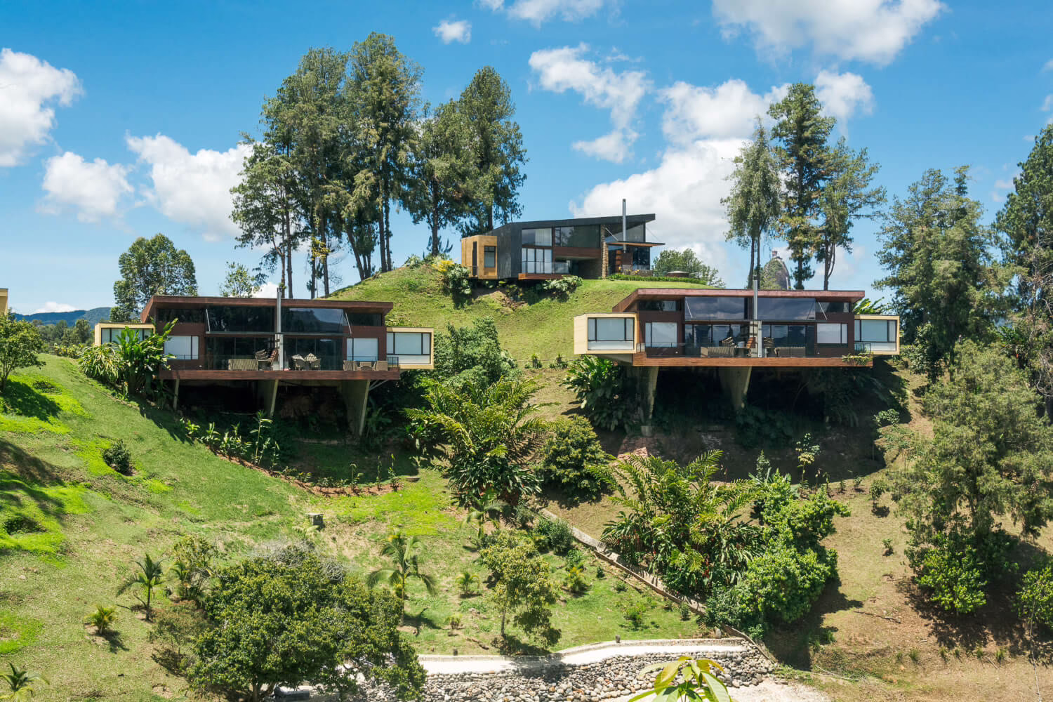 Exterior view of The Charlee Hotel in Medellín, featuring stacked angular balconies, planted terraces, and a distinctive high-rise design
